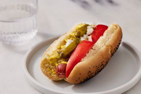 mid angle looking at a Chicago style hot dog on a white plate. 
