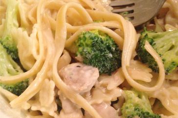 close up view of Chicken and Broccoli Alfredo in a bowl with a fork