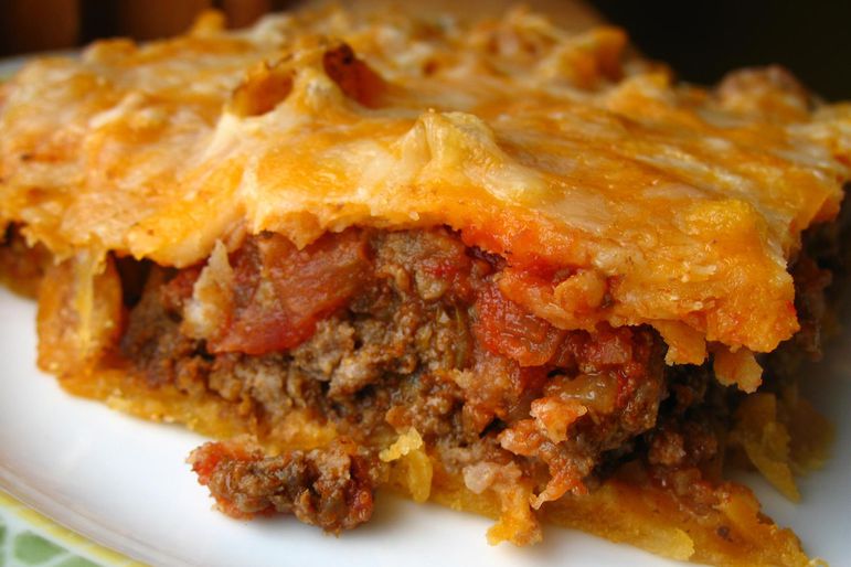 closeup of a crescent roll casserole with ground beef and tomatoes topped with cheese