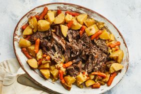 overhead view of pot roast served on a platter with potatoes and carrots