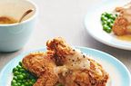portrait shot fried chicken with gravy and peas