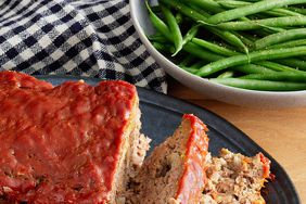 a close up, high angle view of a partially sliced meatloaf ready to serve