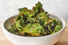 a low angle looking at a heaping bowl full of crispy baked kale chips