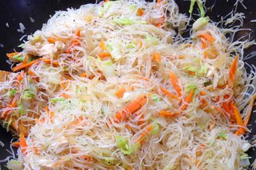 close up view of pancit in a black bowl