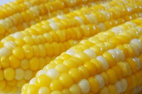 a close-up view of three corn on the cobs