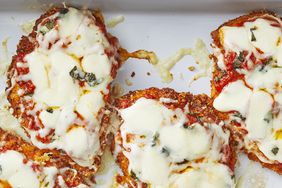 Overhead view of chicken parmesan still in the baking dish and topped with melty cheese