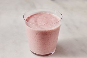 close up view of a small glass of a pink smoothie