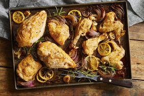 a sheet pan with roasted chicken breast with lemon and rosemary