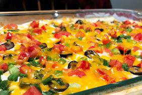 close up view of a Mexican casserole in a glass baking dish