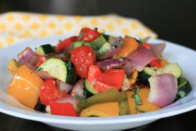 close up view of Sheet Pan Roasted Mediterranean Vegetables in a white bowl