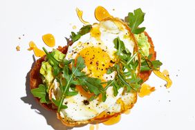 hash browns with sunny side up egg and arugula