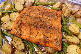 sheet pan of roasted salmon filet atop bed of small potatoes and green beans