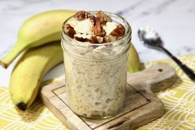 closeup of 1-cup jar with oatmeal bananas, pecans, pineapple on yellow napkin with bananas