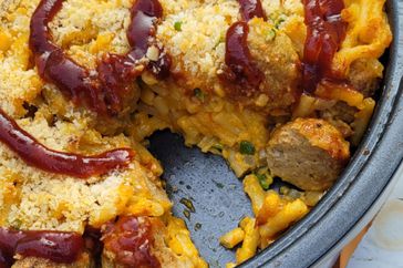 closeup of casserole dish of mac and cheese with meatballs topped with breadcrumbs and barbecue sauce