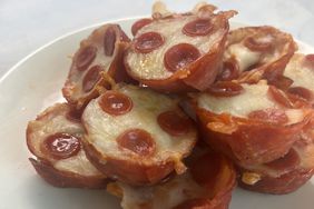 stack of small pepperoni pizza cups on white plate