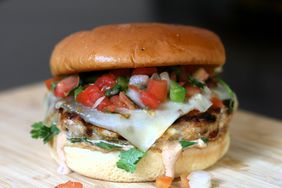perfectly grilled chicken burger with pico de gallo and melted cheese