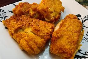 breaded golden-fried cod filets on white plate