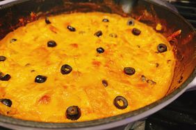 skillet with cheese covered enchilada casserole on stovetop