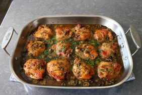 roasting pan with beautifully browned chicken thighs marbella in pan juices