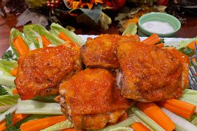 chicken thighs, baked Buffalo-wing-style, on a bed of carrot and celery sticks