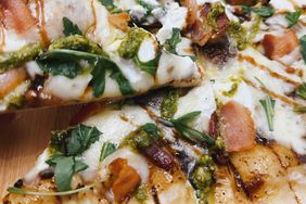 overhead closeup of grilled bacon pizza with arugula