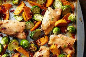 chicken thighs, brussels sprouts, and sweet potatoes roasted on a sheet pan